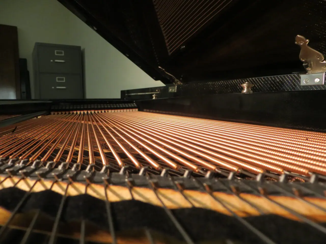 A piano with the strings laid out on it.