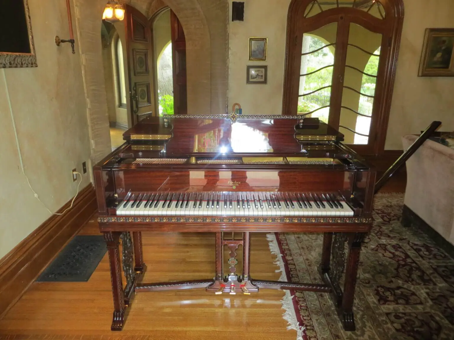 A piano sitting in the middle of a room.