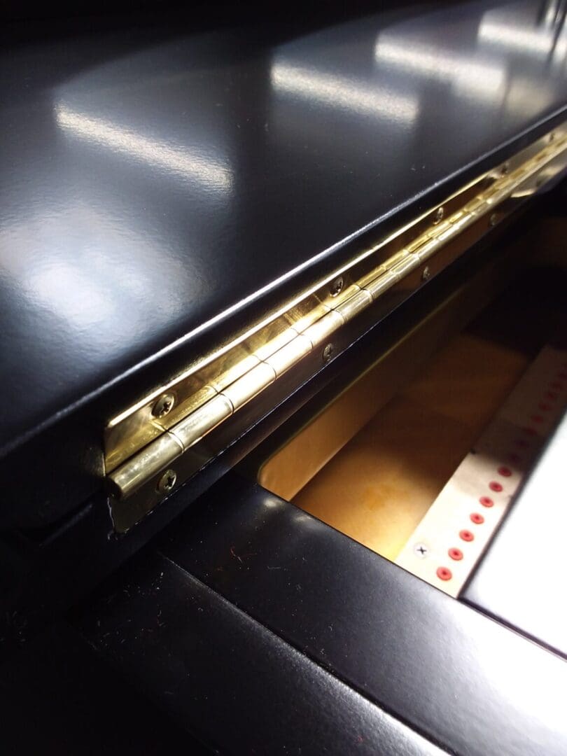 A close up of the inside of an upright piano