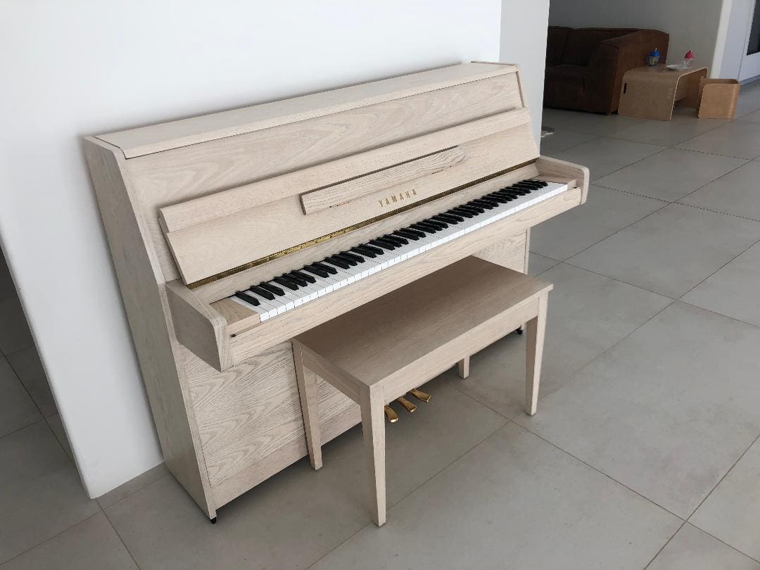 A piano sitting in the middle of a room.