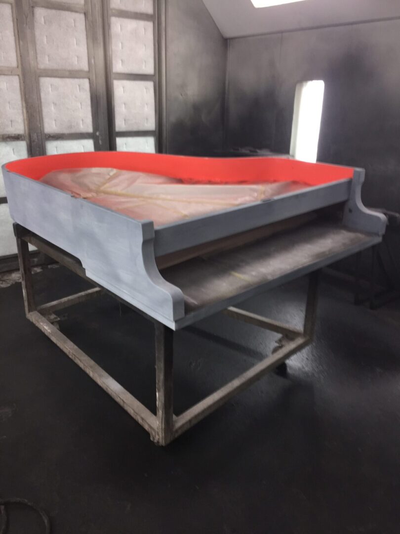 A metal table with red edges on top of it.