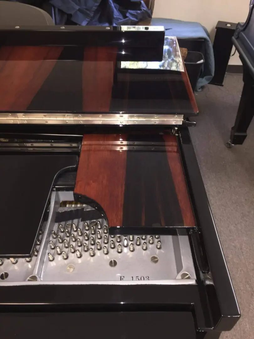 A piano with some wood and metal parts