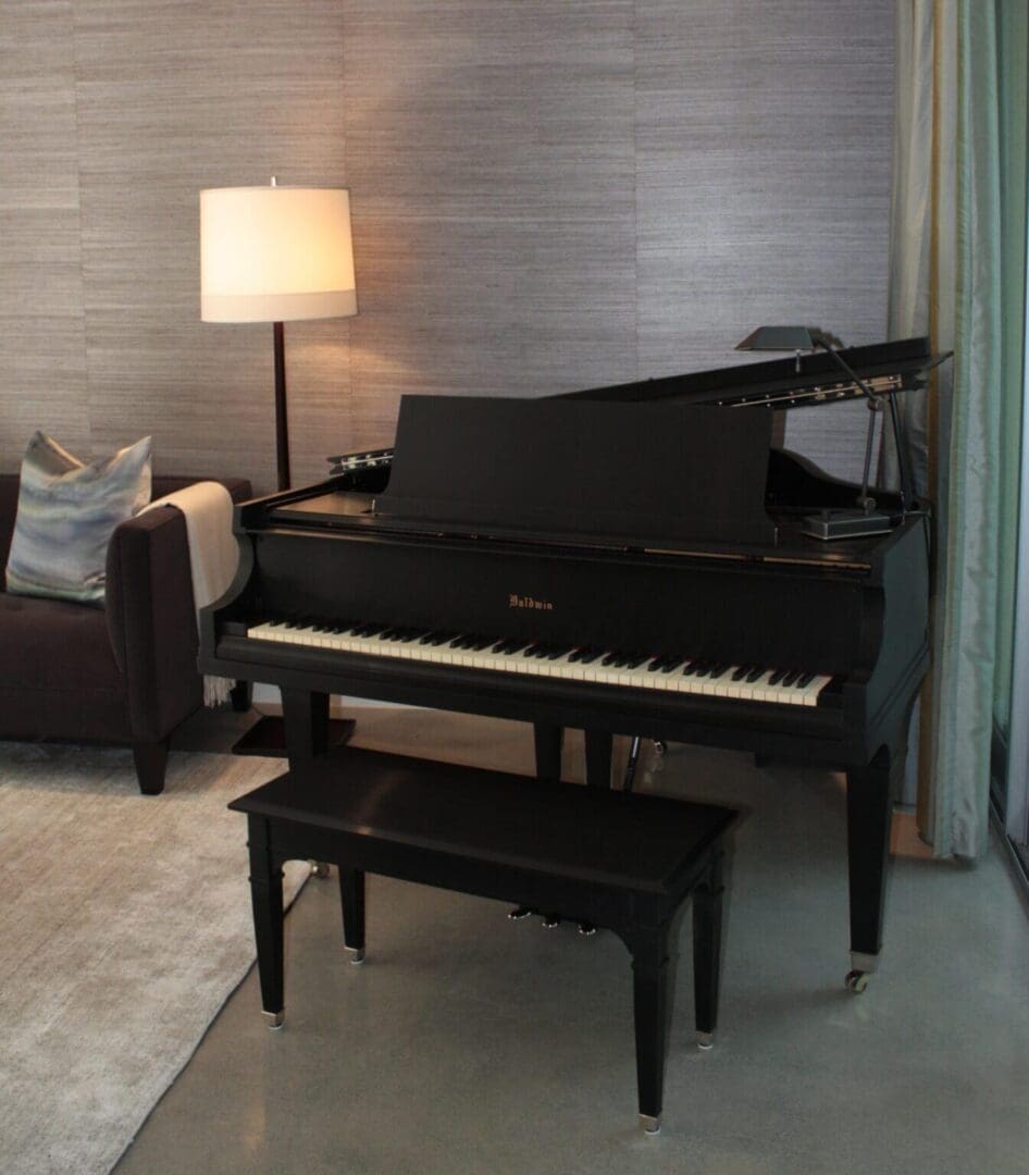A black piano sitting in the middle of a living room.