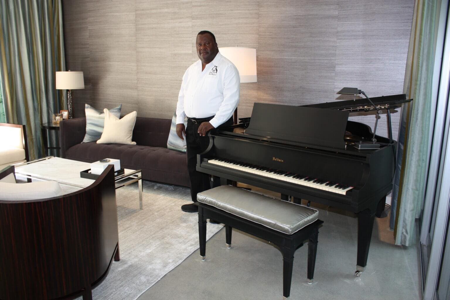 A man standing in front of a piano.